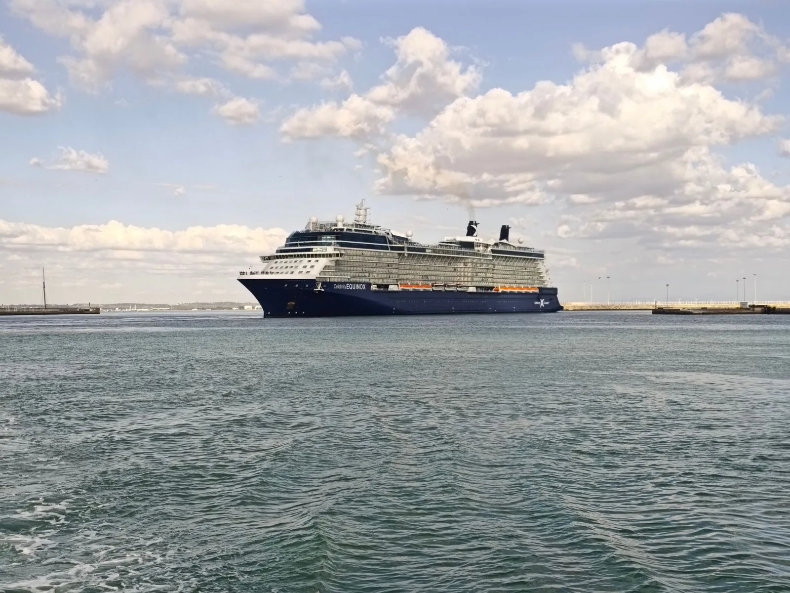 Cruise ship docked at a port of call, with a clear sky overhead